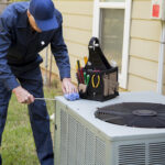 man servicing an air conditioner